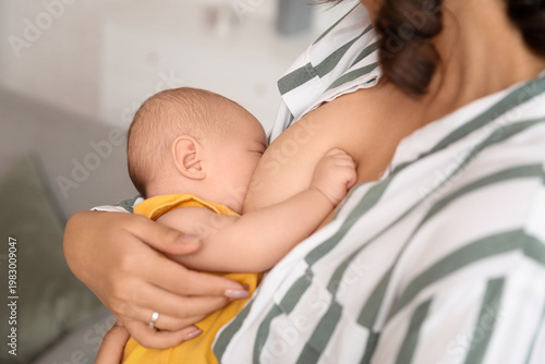 Young woman breastfeeding h...