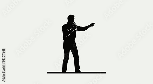 Silhouette of a man singing into a microphone and pointing.