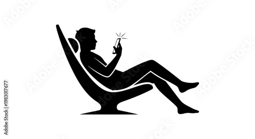 Silhouette of a man relaxing in a modern chair using his smartphone.