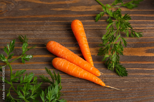 Fresh carrots on wooden table