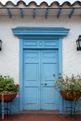 Blue Colonial Door With Rustic White Wall