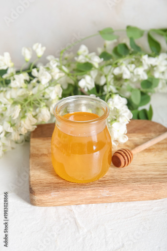 Jar of honey with flowers o...
