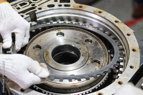 Canvas Print Mechanic hands in white gloves installing a steel clutch plate into a heavy duty automatic transmission assembly during a professional gearbox repair and maintenance service