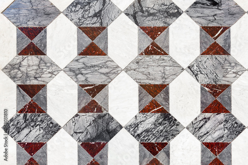 Stone graphic pattern floor, checkered board flooring, symmetric tiled surface combining marble and granite textures. Decorative surface, close-up.