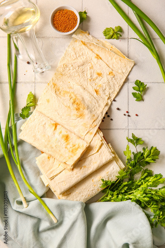 Fresh lavash on white tile background