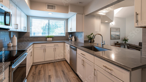 Kitchen renovation showcases an open layout with sleek white cabinets and integrated stainless steel appliances designed for modern residential living spaces.