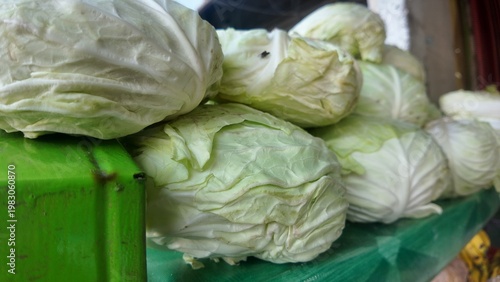 photo of fresh cabbage that has just been picked from the garden, and is being sold at the market