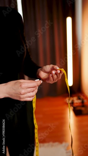 Woman measures body parts in front of mirror during personal assessment