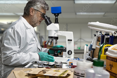 A police ballistics expert examines a seized bullet under a microscope