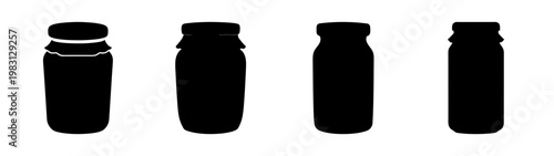 set of four empty glass jars with black lids isolated on white background