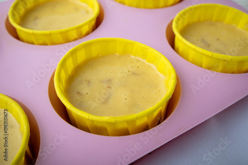 silicone mold with raw cupcake batter up close