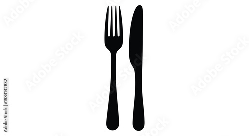 Black cutlery set a fork and knife displayed in a dark silhouette