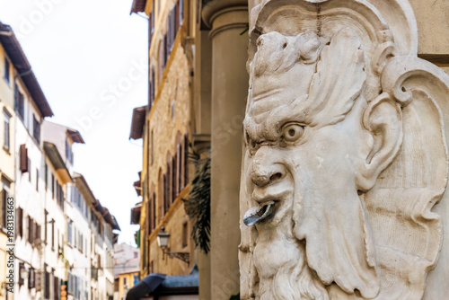 Close up of a public fountain with demon head in the historic center of Florence, Tuscany, Italy, Europe