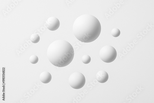 A minimalist 3D composition featuring various white spheres of different sizes floating against a clean, light grey background. The soft lighting and subtle shadows create a sense of depth, elegance, 