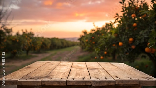 Empty rustic wooden table standing in front of a softly blurred orange grove background with warm natural sunlight and bokeh effect