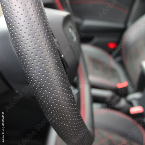 Perforated Leather Upholstery Of Steering Wheel In Modern Car Square Image 
