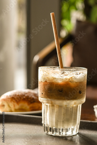 iced coffee with dessert in the background