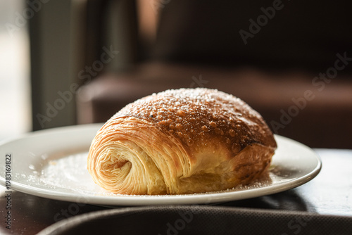 croissant with powdered sugar on the top
