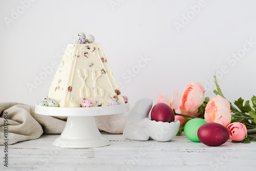Schilderij op canvas Easter vanilla and raisins cottage cheese cake on a cake holder decorated with c