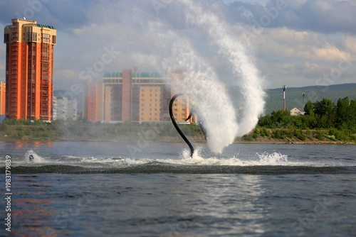 Flyboarding is an extreme water sport and entertainment that allows a person to float in the air above the water using a powerful water flow.