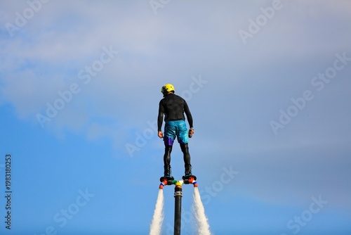 Flyboarding is an extreme water sport and entertainment that allows a person to float in the air above the water using a powerful water flow.