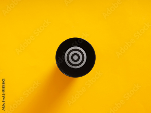 Bullseye target symbol with rings on yellow background
