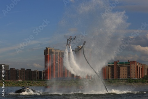 Flyboarding is an extreme water sport and entertainment that allows a person to float in the air above the water using a powerful water flow.