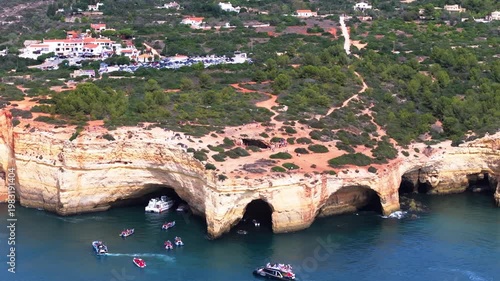 Benagil sea cave Algarve Portugal speedboat along Atlantic coastline aerial