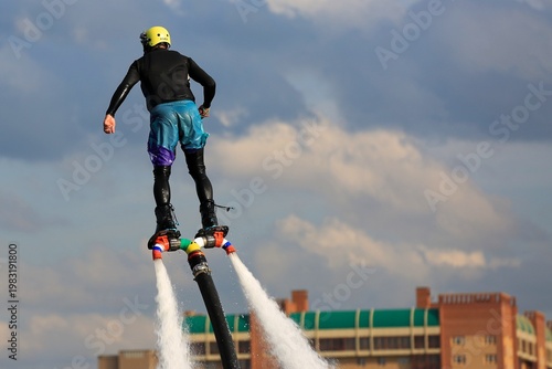 Flyboarding is an extreme water sport and entertainment that allows a person to float in the air above the water using a powerful water flow.