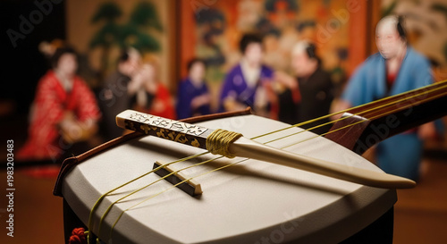 Traditional Japanese musical instrument on display with blurred figures in background