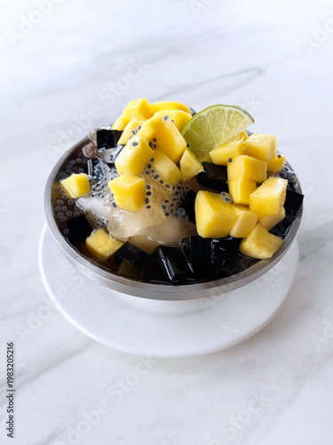 Thai chilled mango sago fruit with chia seed lime and herbal jelly snow iced drink in bowl sweet cold dessert menu cafe halal vegan food
