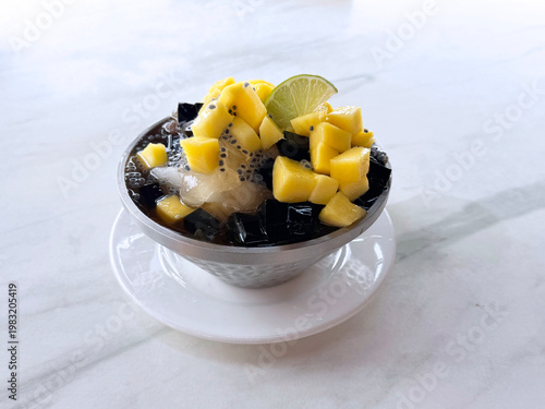 Thai chilled mango sago fruit with chia seed lime and herbal jelly snow iced drink in bowl sweet cold dessert menu cafe halal vegan food
