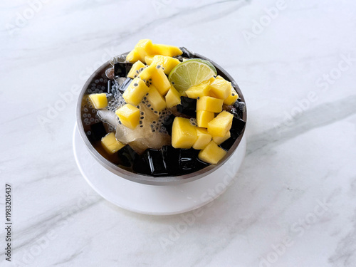 Thai chilled mango sago fruit with chia seed lime and herbal jelly snow iced drink in bowl sweet cold dessert menu cafe halal vegan food

