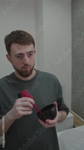 White man mixing beard dye in bowl with brush and gloves preparation for color application, measured pigment, creamy texture