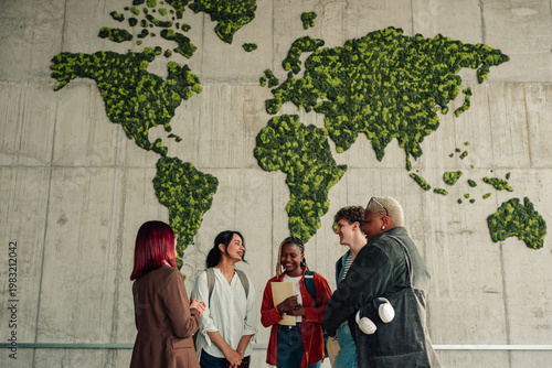 Diverse students connecting in front of an educational moss world map, embracing global unity and environmental sustainability