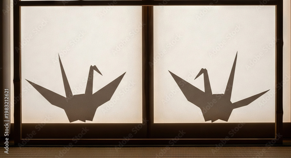 Fototapeta premium Two Origami Cranes Silhouetted Against a Window