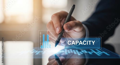 Businessman using digital stylus to interact with holographic capacity chart data analytics, for operational efficiency, resource management, corporate growth potential