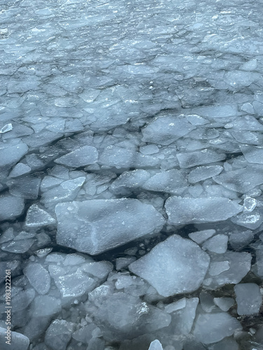 Top view of sea surface with floating ice chunks in winter, cold weather and seasonal nature
