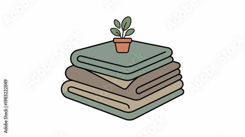 Stacked folded blankets with potted plant