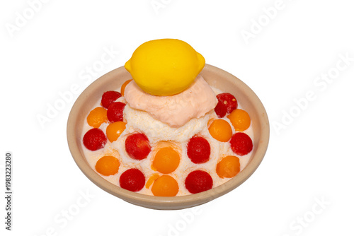 A refreshing bowl of fruit bingsu featuring shaved ice, melon and watermelon scoops, topped with a lemon-shaped dessert and Pocky.