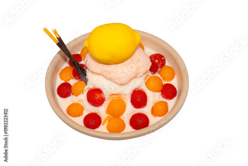 A refreshing bowl of fruit bingsu featuring shaved ice, melon and watermelon scoops, topped with a lemon-shaped dessert and Pocky.