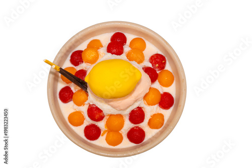 A refreshing bowl of fruit bingsu featuring shaved ice, melon and watermelon scoops, topped with a lemon-shaped dessert and Pocky.