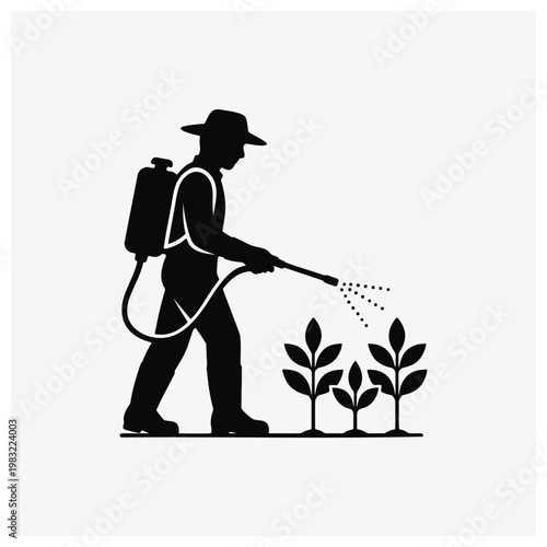 Silhouette of a farmer spraying plants with a pesticide.