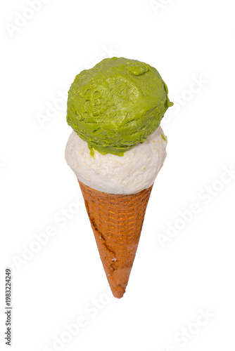 A two-scoop ice cream cone featuring a green matcha top and a white vanilla base nestled in a waffle cone.