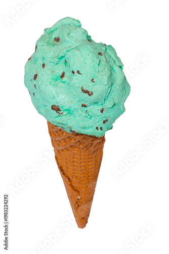 A large scoop of mint chocolate chip ice cream sits atop a brown waffle cone against a plain white background.