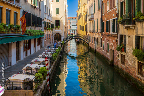 Romantic dining area by the water in Venice, Italy, with historic architecture