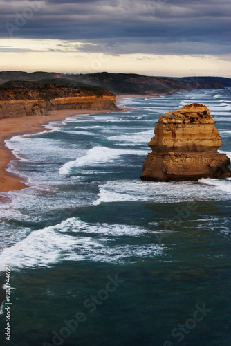 Sea spray over limestone coastline cliffs