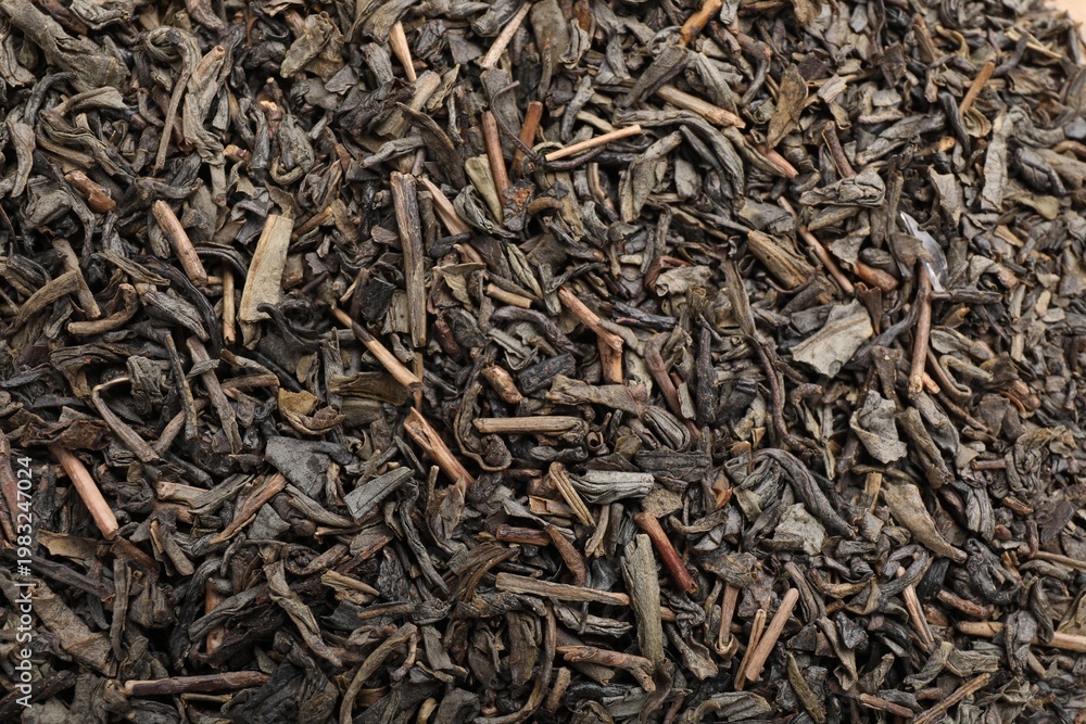 Fototapeta premium Dry herbal tea leaves as background, top view