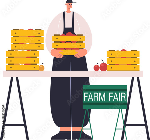 Man holding apple crate establishing farm fair stall