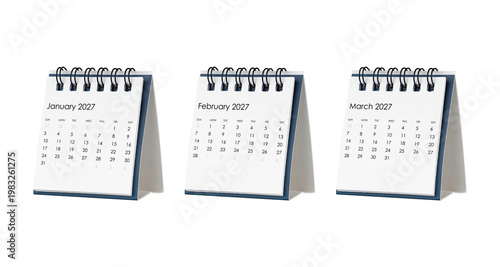 Close up of three spiral desk calendars for the first quarter of 2027. January, February, and March pages displayed for Q1 scheduling, financial goals, and winter season planning. Isolated white backg